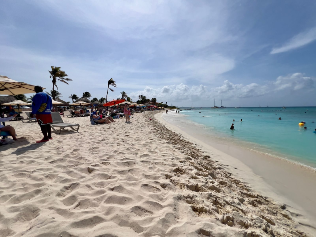 Beachgoers and umbrellas on Arashi Beach in northwest Aruba