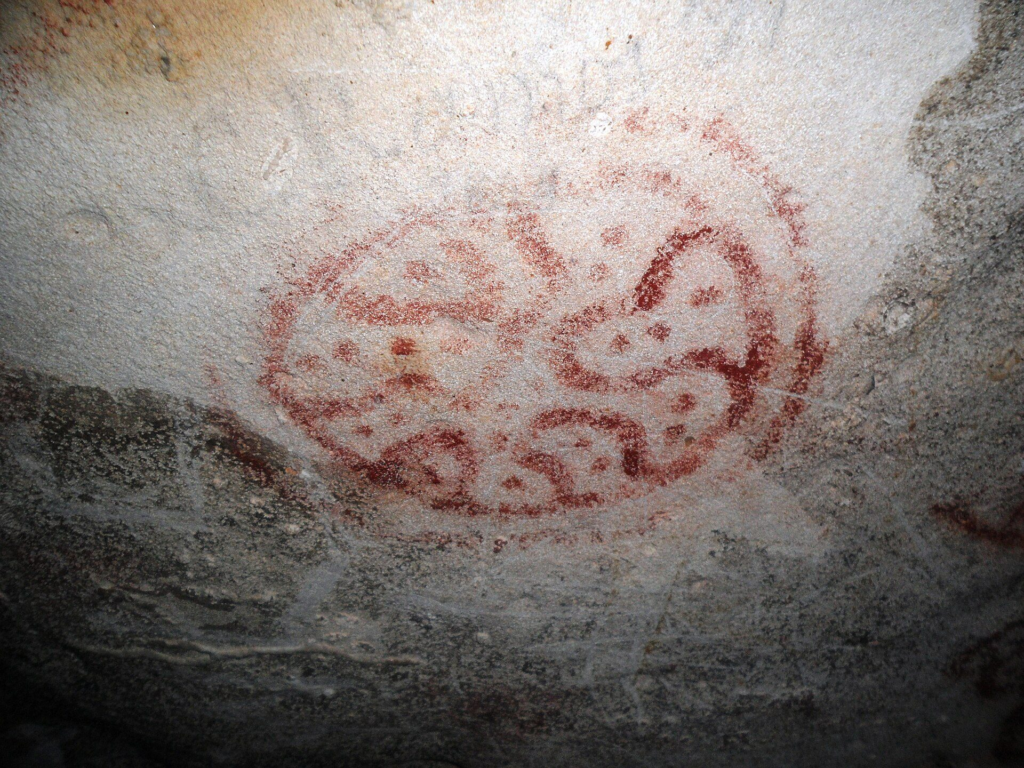 Red Indigenous rock drawings on the ceiling of Fontein Cave, Aruba