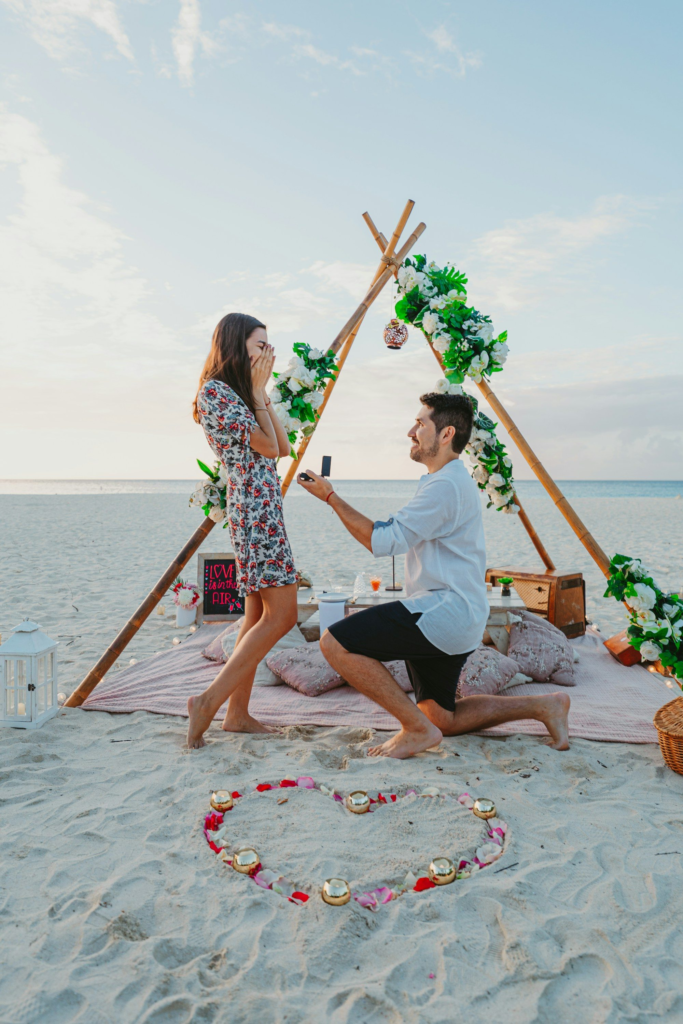 A man proposing to a woman on an Aruba beach at sunset