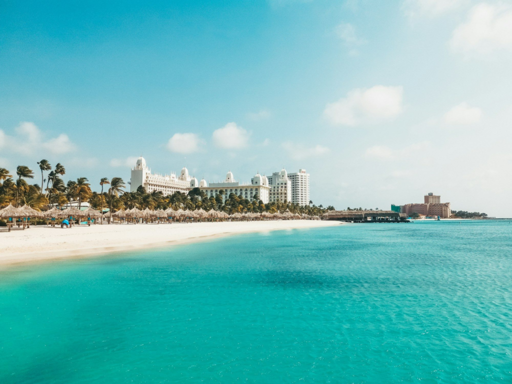 Palm Beach in Aruba with calm water and hotels in the background