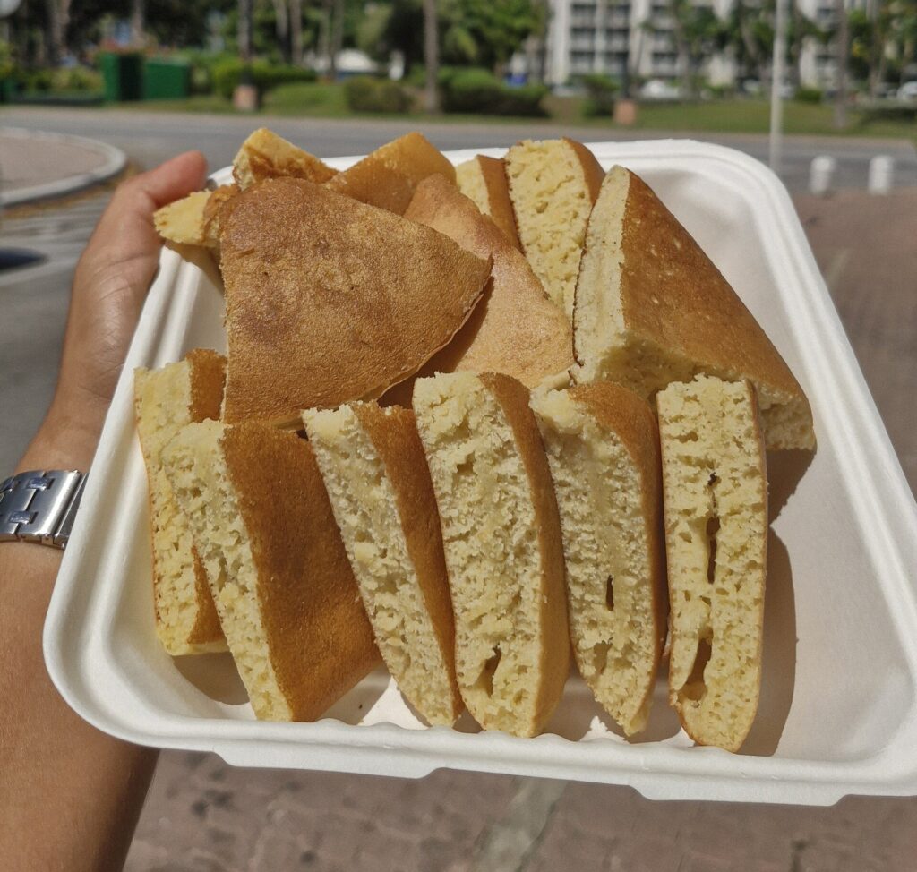 Wedges of pan bati in a takeaway box in Aruba