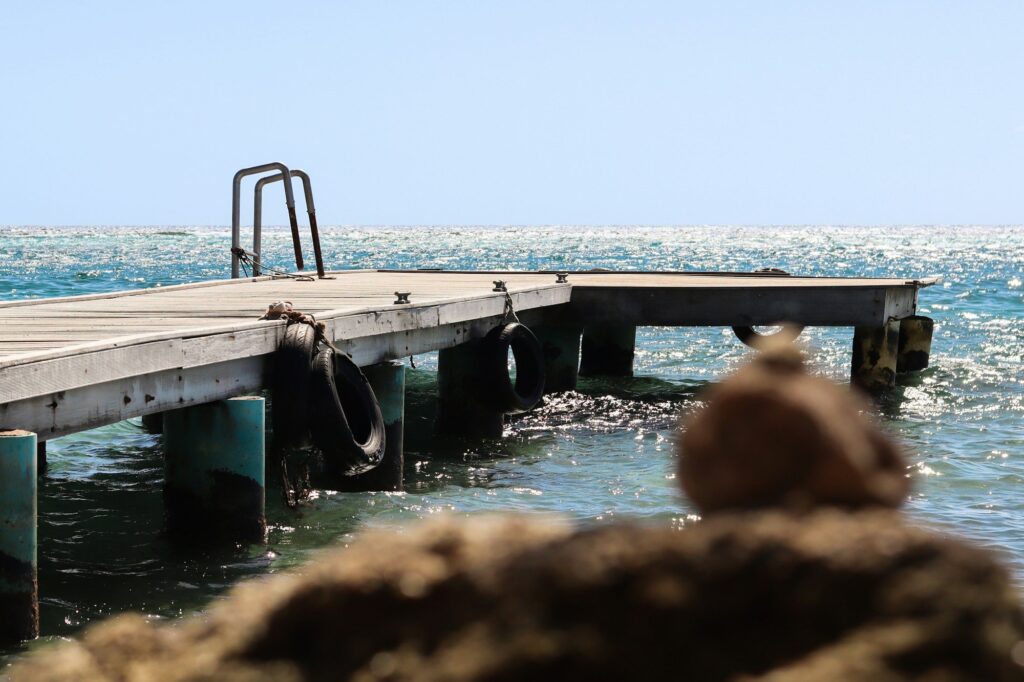Wooden dock over calm water at Mangel Halto, Aruba