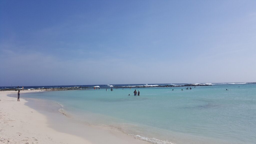 Swimmers in the calm, shallow lagoon at Baby Beach, Aruba