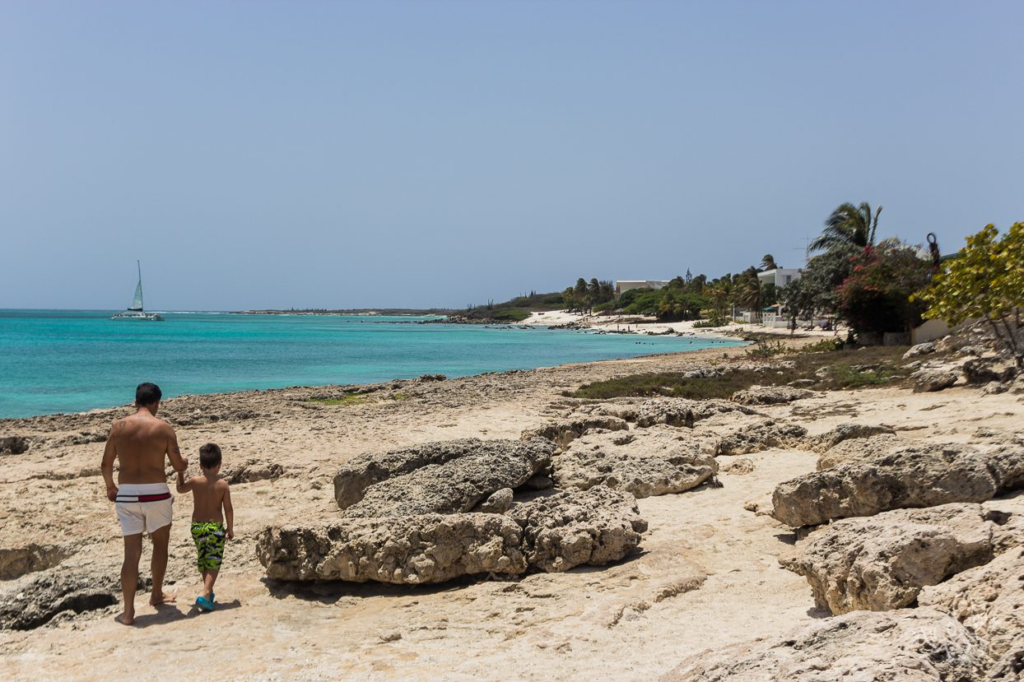 A rocky limestone shore with calm water at Malmok, Aruba