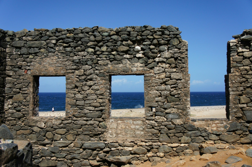 Stone ruins with an ocean view under a blue sky in Aruba