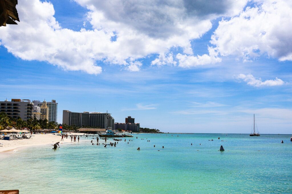 Swimmers relaxing at a beach resort in Noord, Aruba