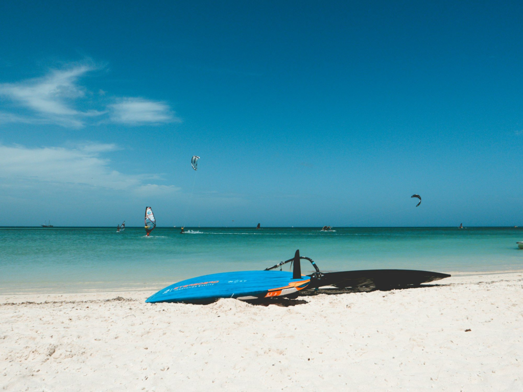 Windsurf board resting on the sand at an Aruba beach during the Hi-Winds event