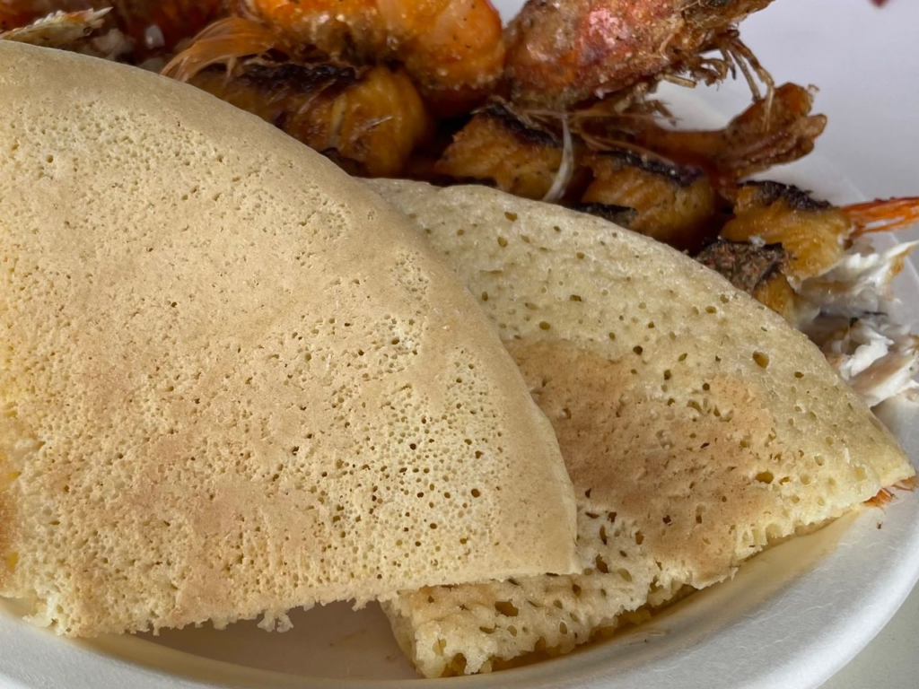 Pan bati served with fried fish and shrimp in Aruba